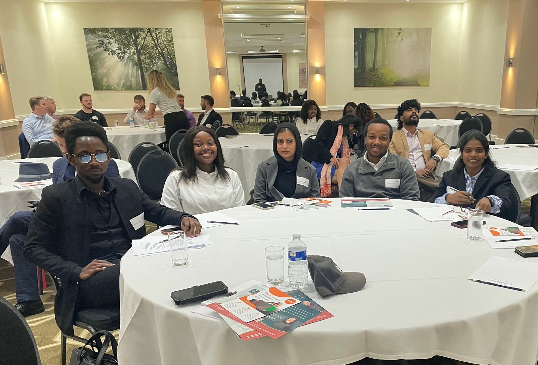 Bridge the Gap project team seated together at a professional engagement event