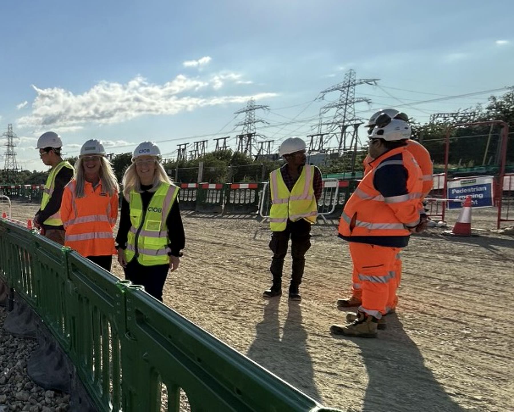 CIOB representatives and site professionals discussing the live construction environment