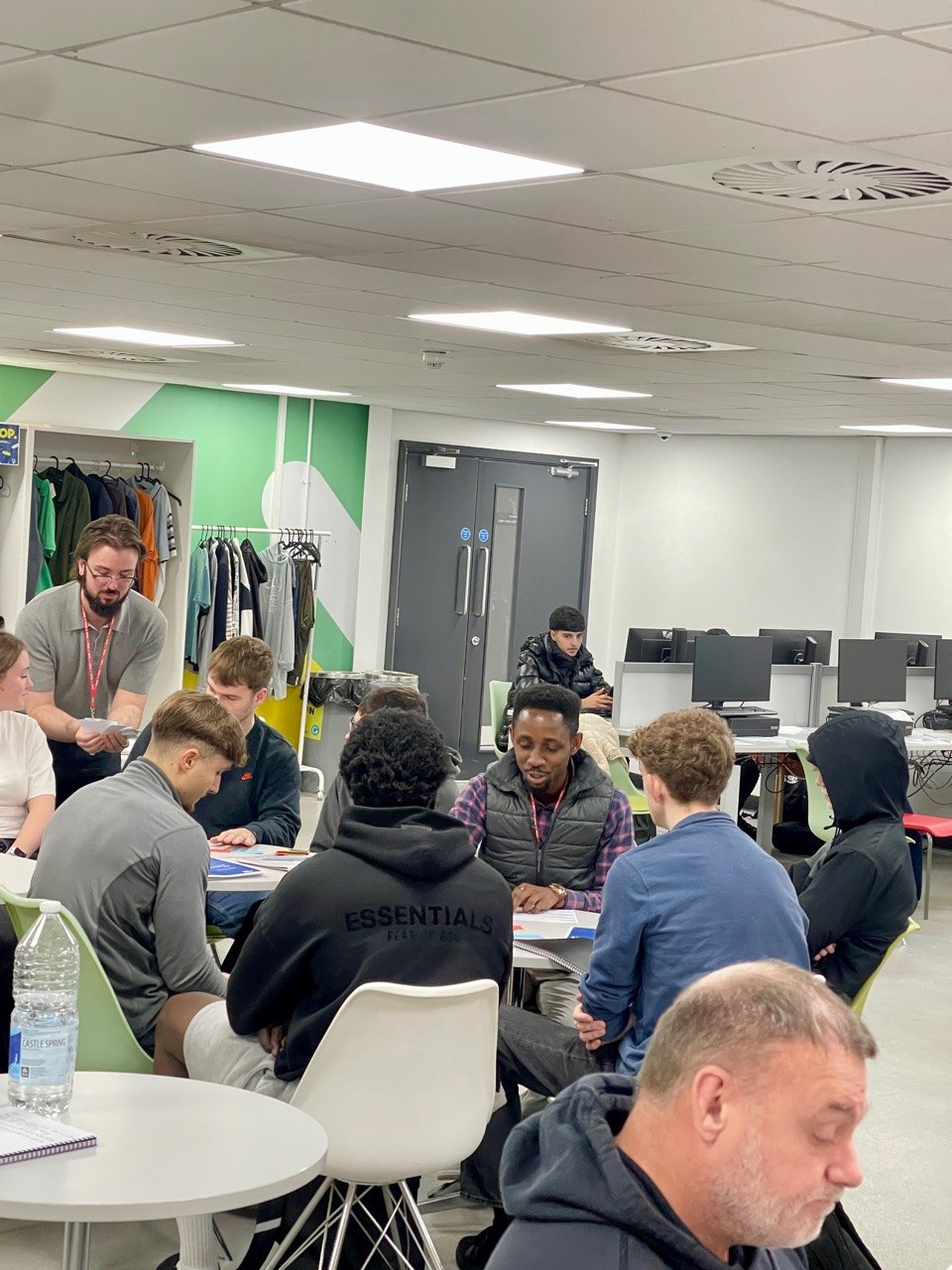 Students and volunteers discussing career pathways around tables during the BRIC activity
