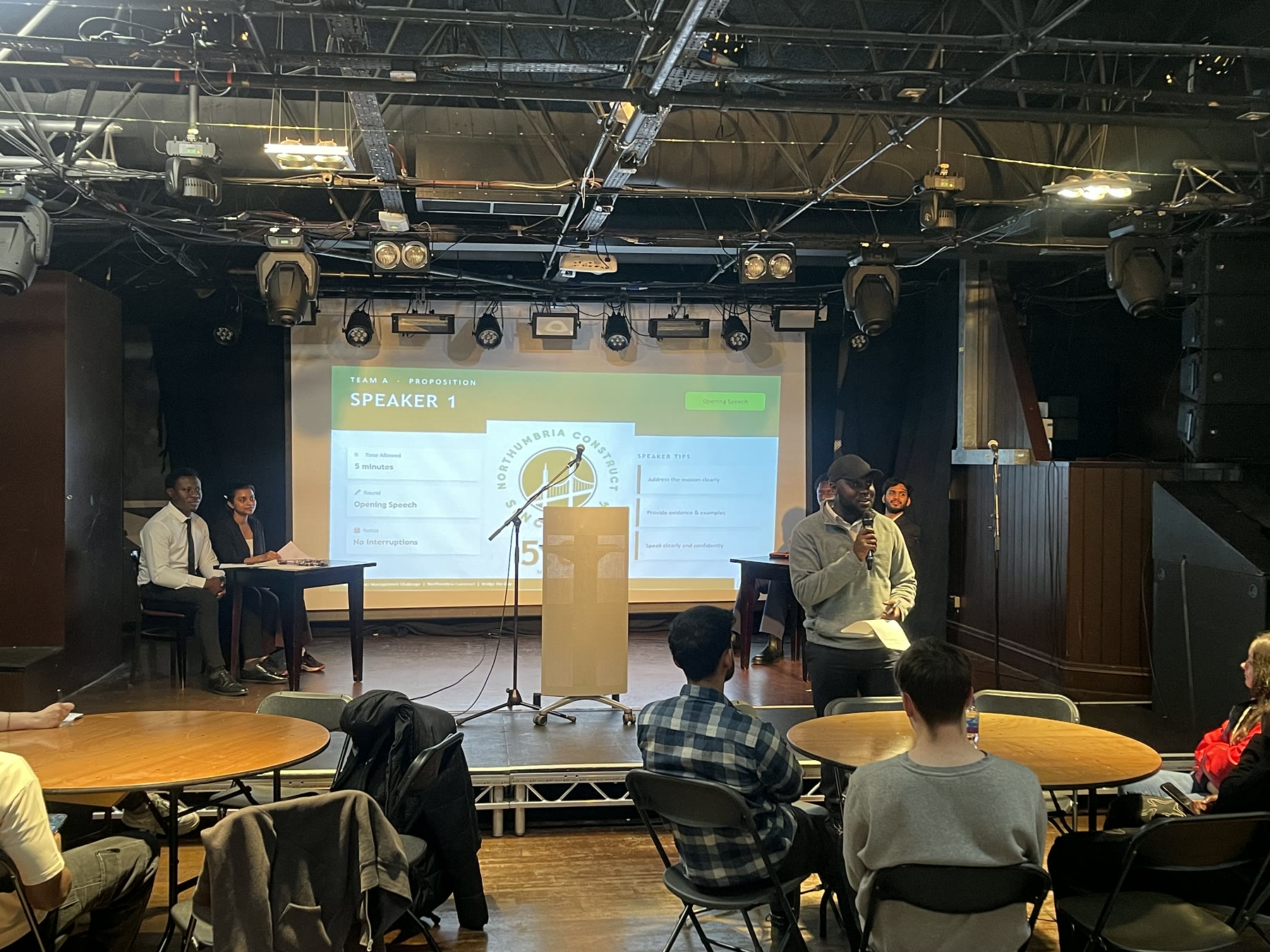 The event host addressing participants during the Oxford-Style Debate