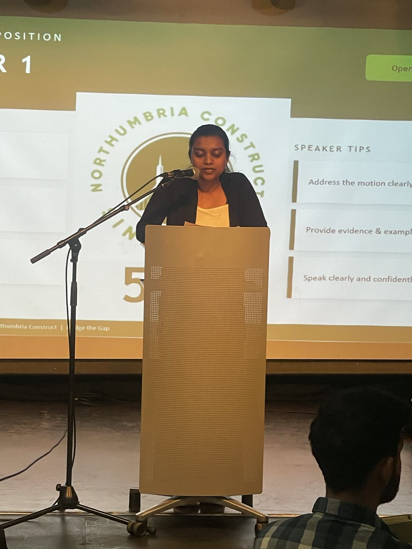 A first-time speaker delivering an opening speech at the Oxford-Style Debate