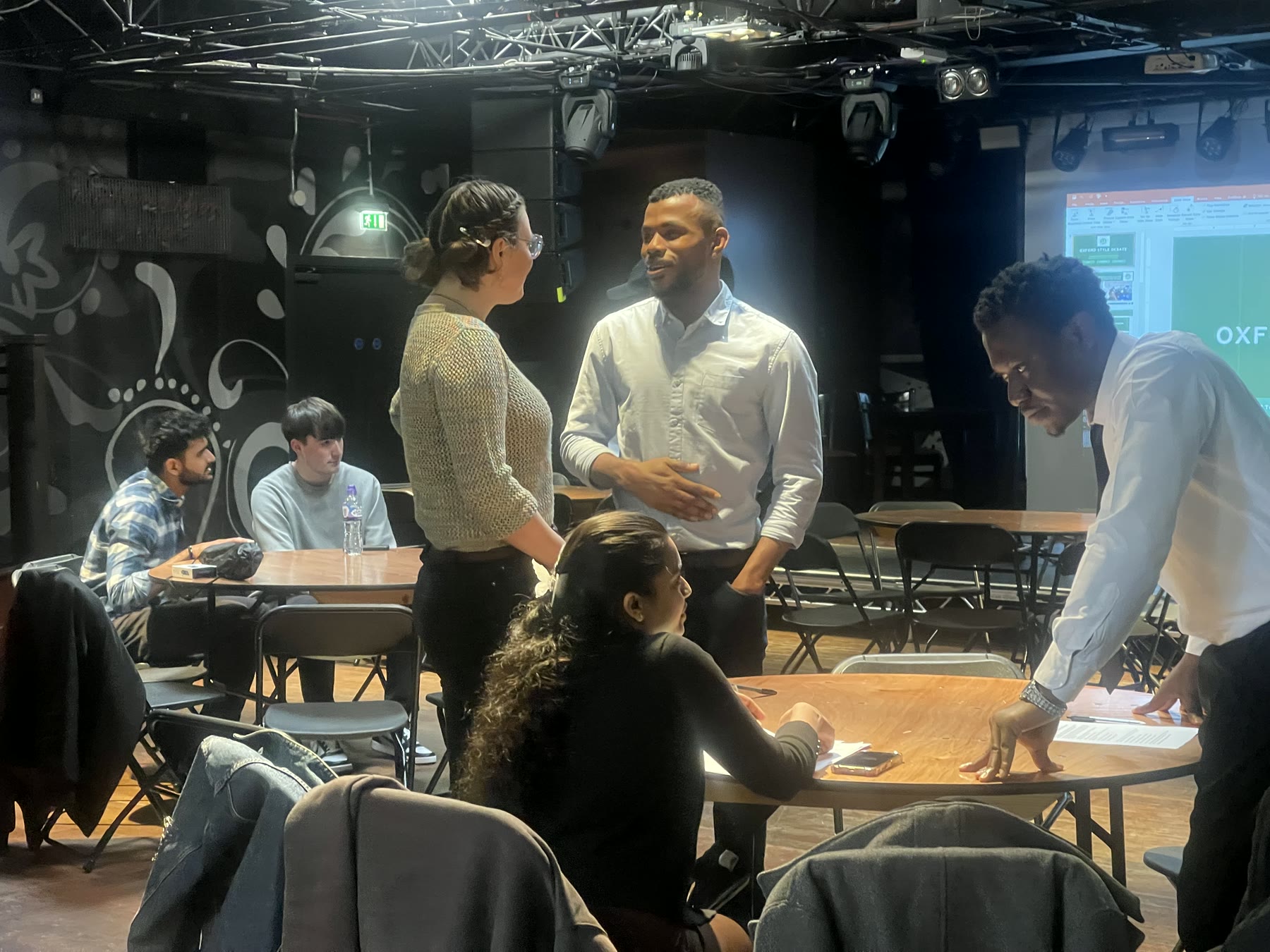 Participants networking and exchanging ideas after the debate