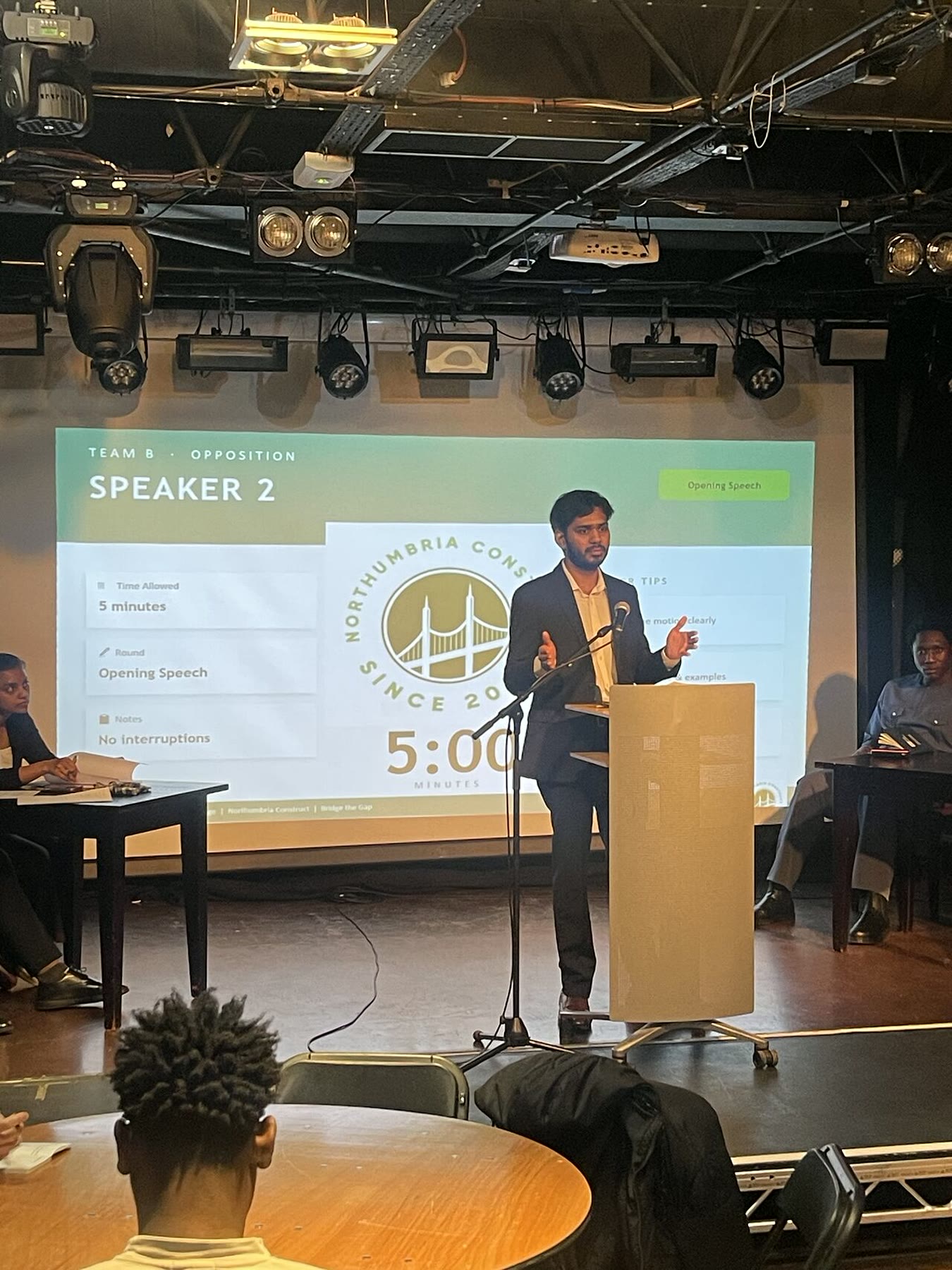 Aditya presenting an opposition argument at the Oxford-Style Debate